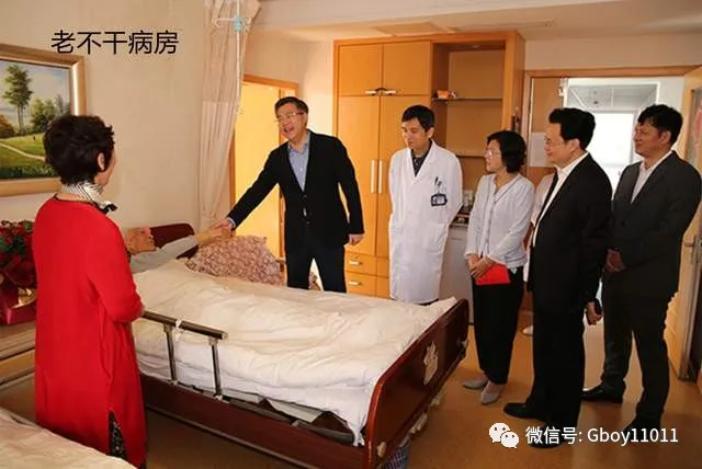 一名医生和几位访客在医院病房里与患者交谈，环境整洁舒适。